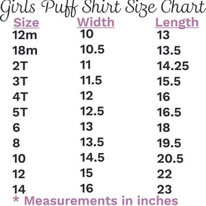May include: A size chart for girls' puff shirts from AJ Blanks, with sizes from 12 months to 14. The chart lists width and length measurements in inches, ranging from 10 inches wide to 23 inches long.