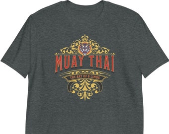 May include: A dark heather grey t-shirt with a gold and red vintage-style logo that says "Muay Thai The Art of 8 Limbs". The logo features a tiger head.
