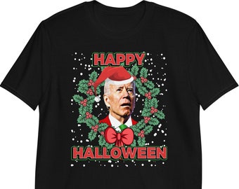May include: Black t-shirt with a red and green wreath design featuring a man wearing a Santa hat. The text "Happy Halloween" is printed below the wreath.