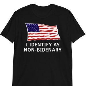 May include: Black t-shirt with a red, white, and blue American flag graphic and the text "I IDENTIFY AS NON-BIDENARY".