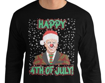 May include: A black long-sleeved shirt with a white snowflake pattern. The shirt features a cartoon image of a person wearing a Santa hat and a red nose. The text "HAPPY 4TH OF JULY!" is printed on the shirt.
