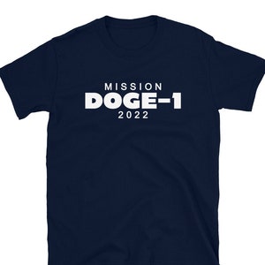 May include: A navy blue t-shirt with white text that reads "MISSION DOGE-1 2022".
