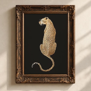 May include: A framed wall art piece featuring a golden leopard with black spots centered on a solid black background. The leopard is depicted in a seated position, facing left. The artwork is enclosed in an ornate, dark brown wooden frame.