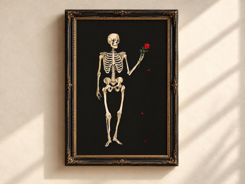 May include: A framed wall art print featuring a beige human skeleton standing against a solid black background. The skeleton holds a single red rose in its left hand, with a few small red rose petals falling below the flower.
