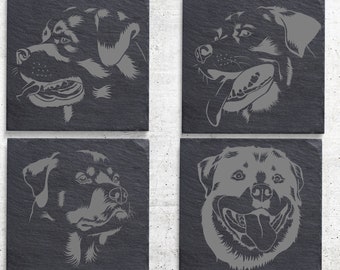 May include: Four black slate coasters with a gray silhouette of a Rottweiler dog on each. The dogs are in different poses, including a side profile, a front-facing pose, and a head-on pose.