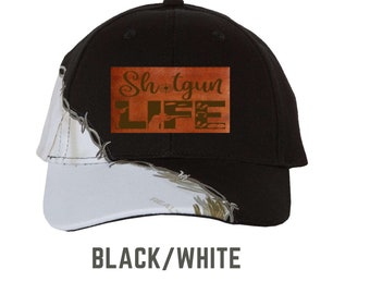 May include: Black and white baseball cap with a brown patch that says "Shotgun Life" in gold lettering.