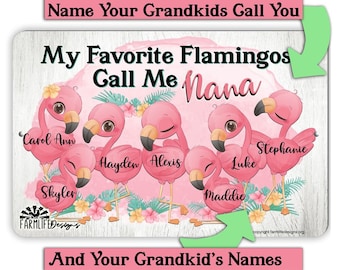May include: Personalized metal sign with a white woodgrain background featuring pink flamingos with names written on them. The sign says "My Favorite Flamingos Call Me Nana" and includes the names Carol Ann, Hayden, Alexis, Luke, Stephanie, and Skyler.