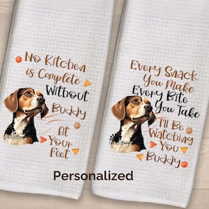 May include: Two white kitchen towels with a brown and white beagle dog illustration. The text on the towels reads "No Kitchen is Complete Without Buddy at Your Feet" and "Every Snack You Make Every Bite You Take I'll Be Watching You Buddy".