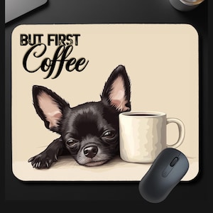 May include: A rectangular mousepad featuring a black Chihuahua dog with a coffee mug. The text "BUT FIRST Coffee" is above the dog. A black computer mouse is next to the mousepad. The background is beige.