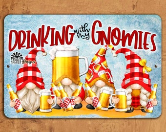 May include: Metal sign with a blue background and the text "Drinking with my Gnomes" in red. The sign features three gnomes wearing red and white checkered hats, holding beer mugs and bottles.