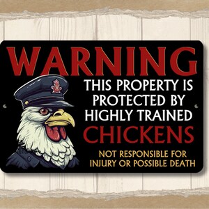 May include: A black and red warning sign with a cartoon chicken wearing a police hat. The sign reads "WARNING THIS PROPERTY IS PROTECTED BY HIGHLY TRAINED CHICKENS NOT RESPONSIBLE FOR INJURY OR POSSIBLE DEATH."