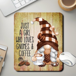 May include: A brown and white gnome with a plaid hat and a coffee cup that says "Coffee". The gnome is holding the coffee cup in its right hand. The background is a woodgrain pattern with the text "Just a girl who loves gnomes & coffee".