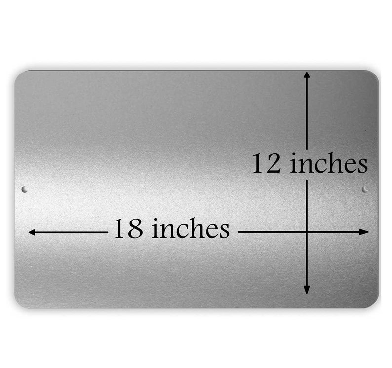 May include: A silver metal sign with black text that reads "18 inches" and "12 inches". The sign is rectangular and has rounded corners.