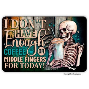 May include: A metal sign with a rustic wood background featuring a skeleton holding a coffee cup. The sign reads "I don't have enough coffee or middle fingers for today!"