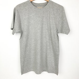 May include: A heather grey t-shirt with short sleeves and a crew neck.