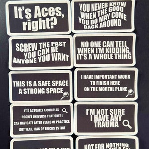 May include: A collection of black and white rectangular patches with various humorous phrases. The patches have a white border and feature text like "It's Aces, right?" and "I'm not sure I have any trauma."