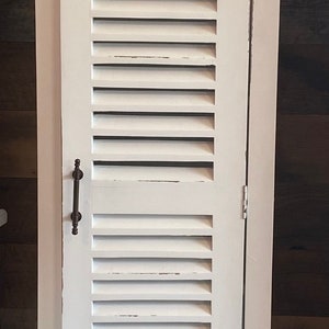 White shutter style closed cabinet