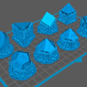 May include: A set of nine blue dice with different numbers on each face. The dice are arranged in a grid pattern on a blue and white grid surface.