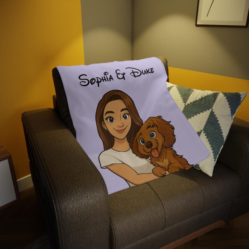 May include: A lilac throw blanket with a cartoon illustration of a woman and a dog. The woman has brown hair and wears a white top. The dog is brown. The blanket has the text "Sophia & Duke" in black script.