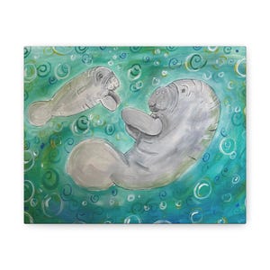 May include: A canvas print depicting two grey manatees in a teal and green ocean with bubbles. One manatee is above the other, both appearing to interact. The background is a mix of teal and green, creating a vibrant underwater scene.