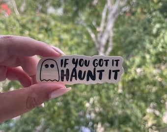 May include: A white sticker with a ghost illustration and the phrase "IF YOU GOT IT HAUNT IT" in black lettering. The sticker is rectangular and has rounded corners, perfect for Halloween.