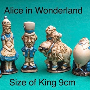 May include: A collection of six Alice in Wonderland figurines. The King figure is 9cm tall. The figurines are in cream, blue, and white. Characters include the King, Alice, the Mad Hatter, a horse, Humpty Dumpty, and the White Rabbit.