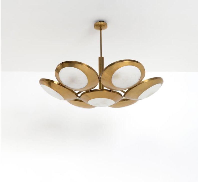 May include: A brass and white glass chandelier with a circular design. The chandelier has seven lights and a modern style.