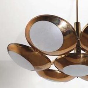 May include: A brass and white ceiling light fixture with six circular shades. The shades are arranged in a flower-like pattern.