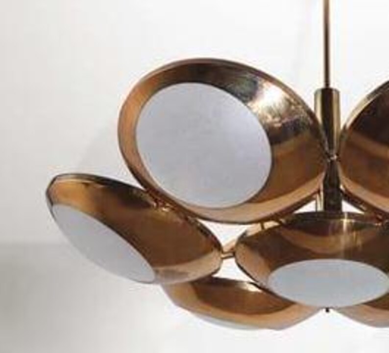 May include: A brass and white ceiling light fixture with six circular shades. The shades are arranged in a flower-like pattern.