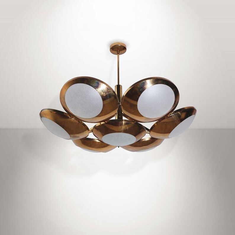 May include: A brass and white glass chandelier with six lights. The chandelier has a modern design with a circular shape.