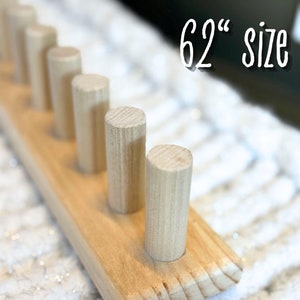 May include: A wooden dowel rod holder with 6 dowels. The holder is made of natural wood and has a smooth finish. The dowels are 62 inches long.