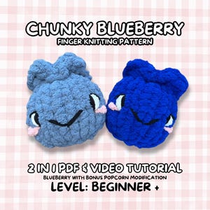 May include: Two handmade, chunky blueberry-shaped finger knitting projects. One is light blue, the other is dark blue. Each has white eyes, pink cheeks, and a smiling mouth. The text reads "CHUNKY BLUEBERRY FINGER KNITTING PATTERN" and "LEVEL: BEGINNER +".