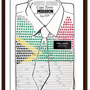 May include: Framed artwork featuring a shirt design with the text "SOUTH AFRICA Cape Town MISSION July 2024." The shirt design incorporates the colors of the South African flag. Includes the name "Elder Adams" and "THE CHURCH OF JESUS CHRIST OF LATTER DAY SAINTS."