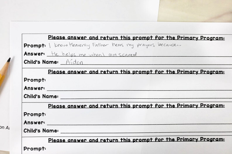 May include: A white paper form with black text featuring the heading Please answer and return this prompt for the Primary Program. The first section includes the prompt I know Heavenly Father hears my prayers because, the answer He helps me when I am scared, and the name Aiden written in pencil.