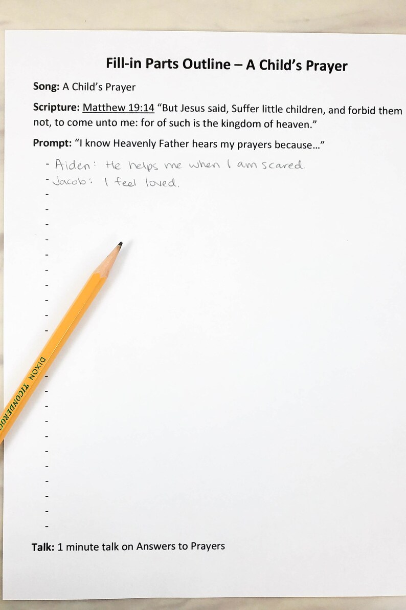 May include: A white paper sheet titled Fill-in Parts Outline &ndash; A Child&rsquo;s Prayer with printed text including Matthew 19:14 and a prompt. Two handwritten lines are present, and a yellow Dixon Ticonderoga pencil rests diagonally across the left side.