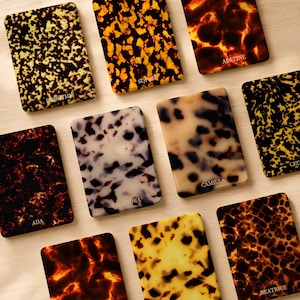 May include: A collection of ten rectangular cases featuring various tortoiseshell patterns in shades of amber, black, brown, and cream. Each case is personalized with a name printed in white, including Dorothy, Sophie, Adeline, Ada, Eleanora, Camilla, and Beatrice.