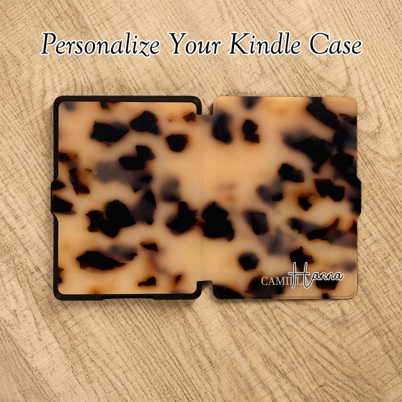 May include: A rectangular Kindle case featuring a brown and black tortoiseshell pattern. The text "Personalize Your Kindle Case" appears at the top, and the name "CAMILLA Hanna" is printed in white script in the bottom right corner of the case.