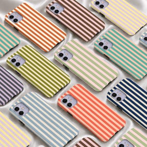 May include: A collection of rectangular smartphone cases featuring various two-tone vertical striped patterns in colors including orange, brown, yellow, green, teal, purple, blue, and coral, each with a dual-lens camera cutout in the corner.