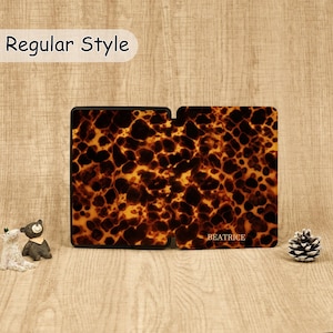 May include: A rectangular e-reader case featuring a brown and black tortoiseshell pattern. The right side of the case displays the name BEATRICE in gold lettering. The text Regular Style appears in a white bubble at the top of the image.
