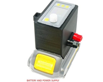 May include: A black and gray device with a yellow button and a digital display. The device has a white knob and red and black connectors. The text "BATTERY AND POWER SUPPLY NOT INCLUDED" is at the bottom.