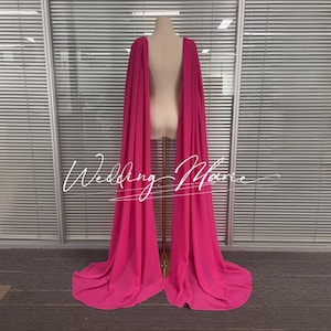 May include: A hot pink sheer cape with a long train. The cape is made of a lightweight fabric and has a simple design.