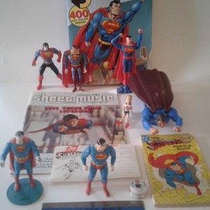 SUPERMAN VINTAGE COLLECTABLES--1970's-90's Lot of 12 Pieces, Books, 7up Contest & Action Figures