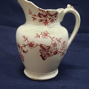 Vintage White and Red Floral-Patterned Pitcher with Handle and Bulbous Design