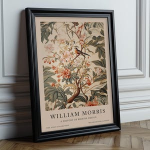 May include: A framed poster featuring a vintage illustration of a bird perched on a branch of a flowering tree. The poster is titled "William Morris: A History of British Design" and includes the text "The Avian Collection" and "Walthamstow, London".