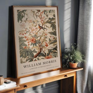 May include: A vintage poster featuring a botanical illustration of a flowering branch with a small bird perched on a stem. The poster is titled "William Morris, A History of British Design, The Avian Collection, Walthamstow, London."