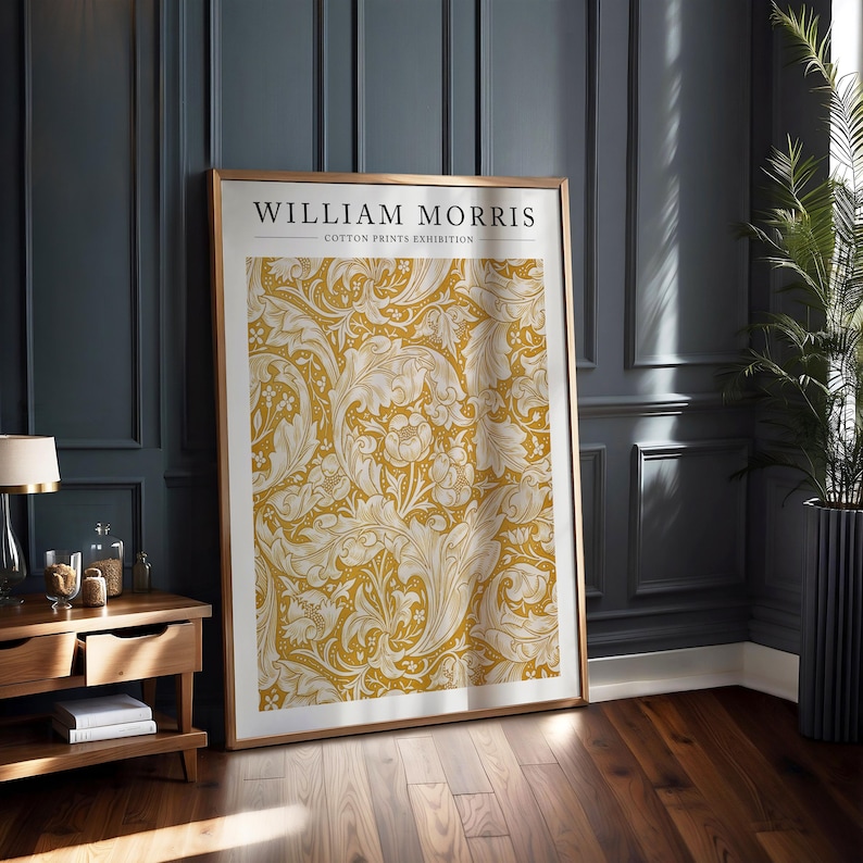 May include: A framed poster with a gold background and white floral pattern. The poster reads "William Morris - Cotton Prints Exhibition".