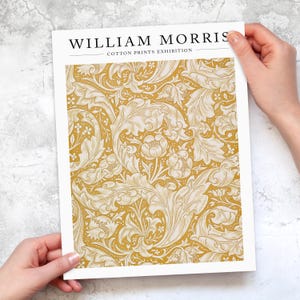 May include: A poster advertising a William Morris cotton prints exhibition. The poster features a yellow background with a white floral pattern.