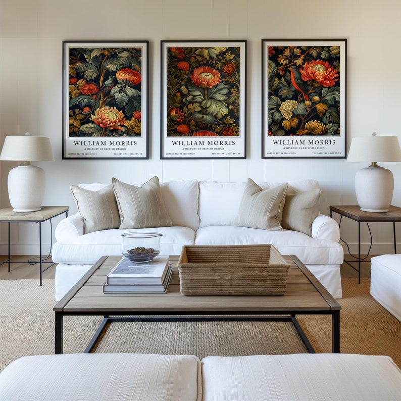 William Morris Bird & Floral Print Set of Three displayed against a neutral background, featuring vibrant orange flowers and delicate birds nestled among lush foliage. These botanical wall art prints bring vintage elegance to your wall decor.