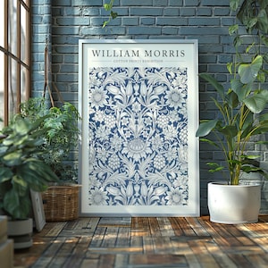 Puede incluir: Una impresi&oacute;n enmarcada de un patr&oacute;n floral azul y blanco con el texto "William Morris Cotton Prints Exhibition".