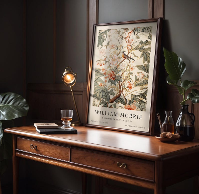 May include: A framed print of a botanical illustration featuring a bird perched on a branch with flowers and leaves. The print is titled "William Morris, A History of British Design".